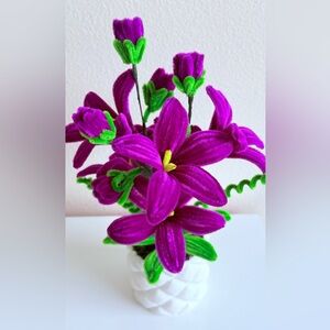 Purple and Green Floral Arrangement in White Pot